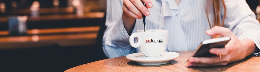 Girl drinking coffee using Red Tomato coffee mug