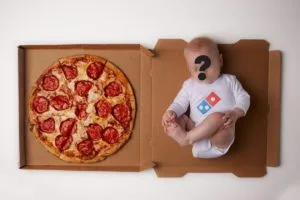Dominos Pizza with a baby on the right side